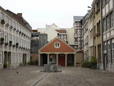 A quaint courtyard with historic buildings and a small pavilion.