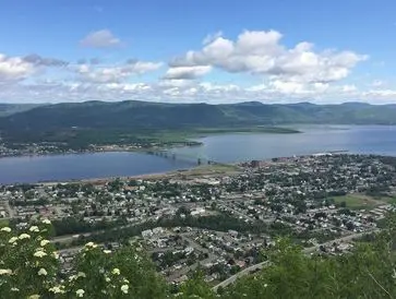 A coastal town with mountains and a large body of water.