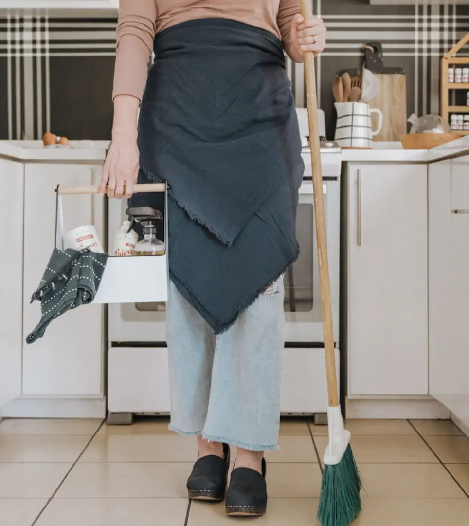 Person wearing a unique apron standing in a modern kitchen.