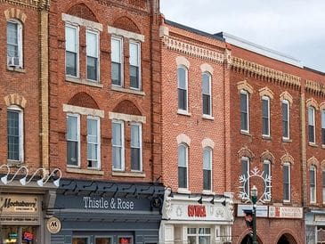 Historic red brick storefronts with distinct architectural details.