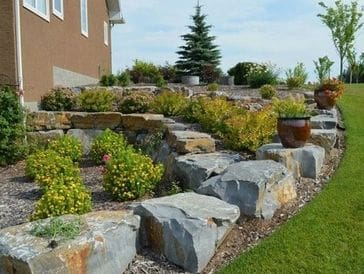 A landscaped garden with large rocks and greenery.