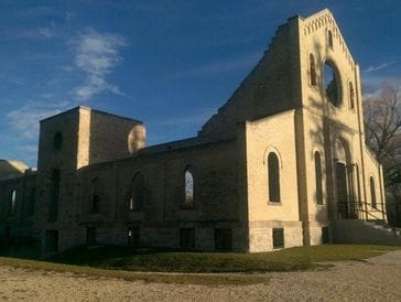 Historic stone building under a clear blue sky.