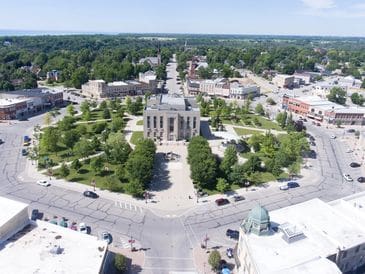 Aerial view of a historic courthouse surrounded by greenery and streets.