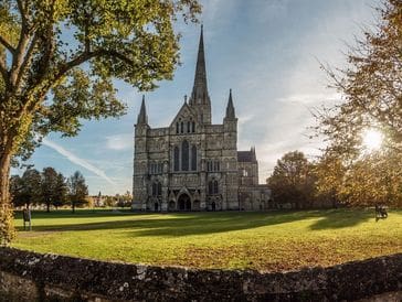 A majestic Gothic cathedral with tall spires under a clear sky.