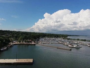 A marina with boats docked under a cloudy sky.