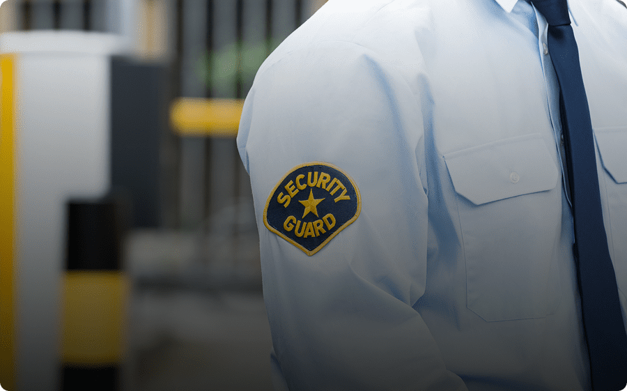 Close-up of a security guard's uniform patch on the sleeve.