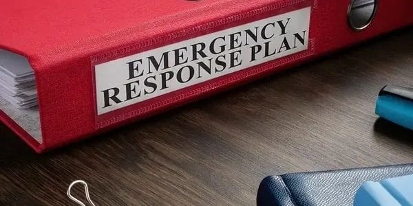 Close-up of an Emergency Response Plan binder on a desk.