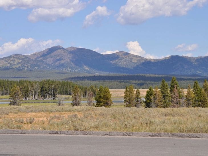 Scenic mountain landscape under a partly cloudy sky.