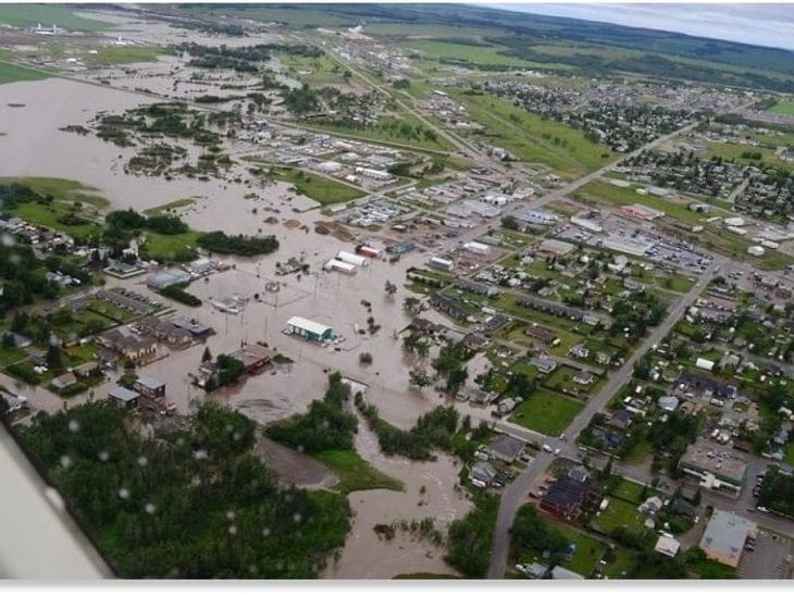 Aerial view of a flooded town with submerged streets and buildings.