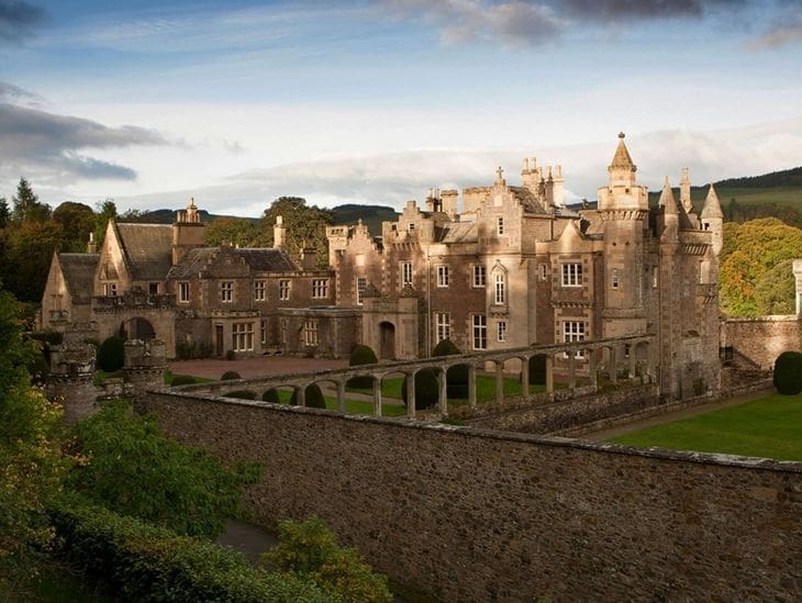 Historic castle under a cloudy sky at sunset.