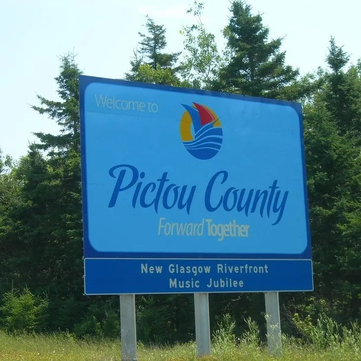 Pictou County welcome sign by trees