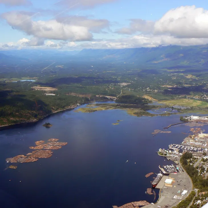 Aerial view of coastal harbor and log booms