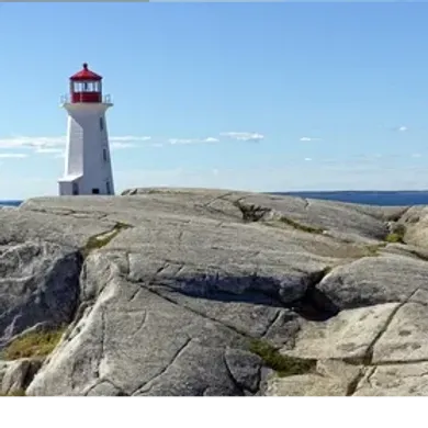 Lighthouse with red top on rocky shore